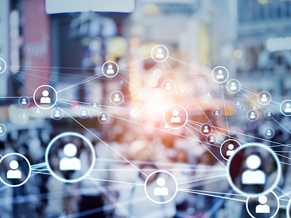 interlinked icons of people over blurry crowd and buildings